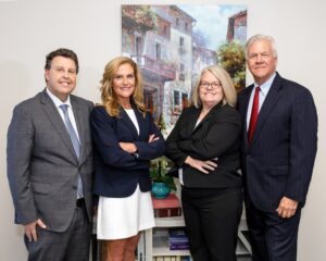 Group photo of four lawyers in our law group, all associates at Guffey & Kostun Law Group